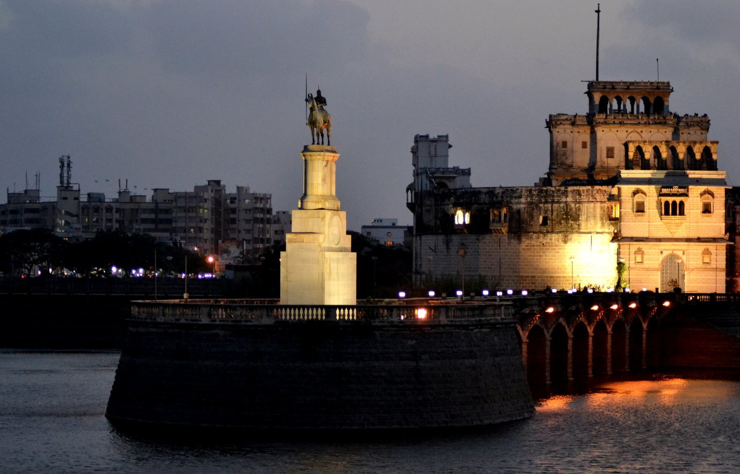 Lakhota Palace lit up at dusk on Lakhota Lake, Jamnagar