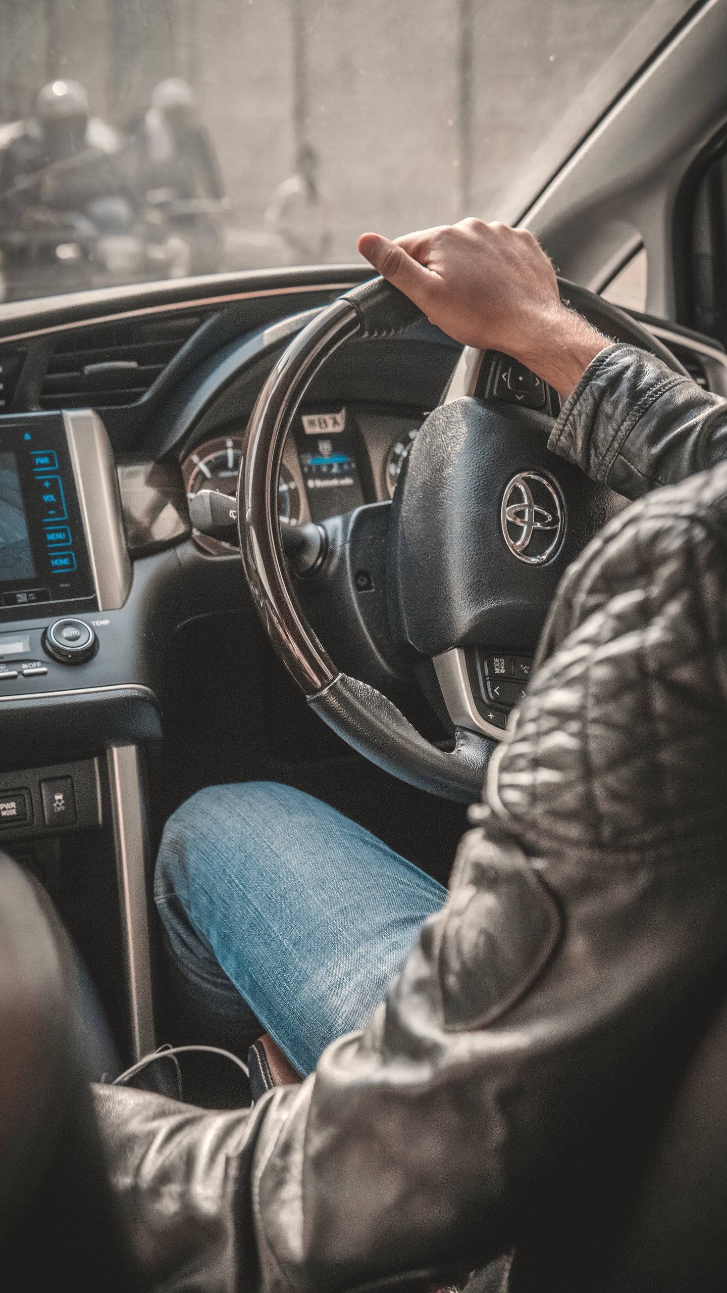 Driver’s hands on the steering wheel during a journey
